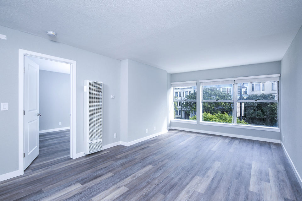 Spacious living room with modern decor and natural light at 230 Dolores Apartments