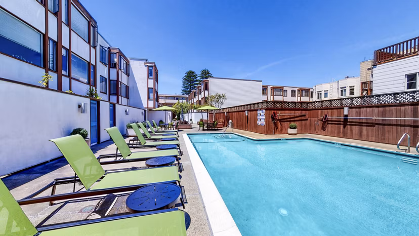 Luxurious outdoor pool at 230 Dolores Apartments with poolside seating and lush landscaping, perfect for relaxation