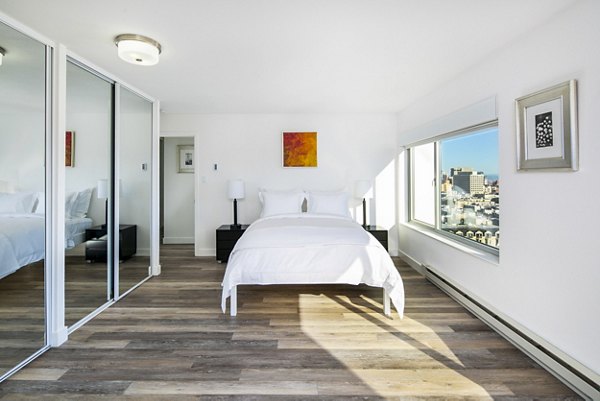 Cozy bedroom with modern furnishings at Clay Park Tower Apartments in San Francisco
