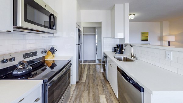 Modern kitchen with stainless steel appliances at Clay Park Tower Apartments