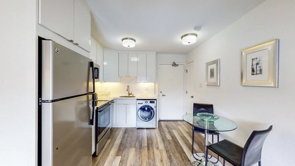 Kitchen with modern appliances and sleek countertops in Clay Park Tower Apartments