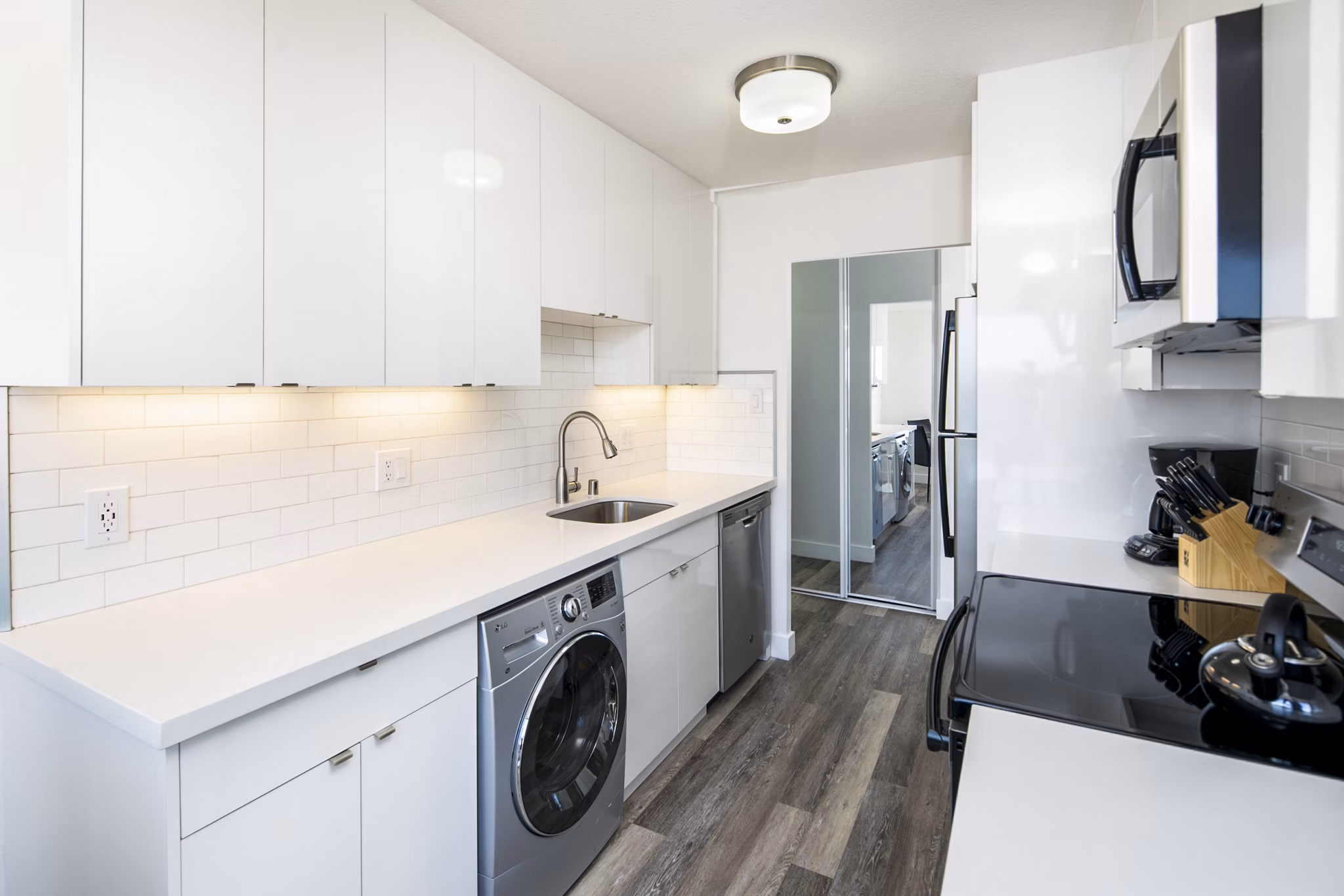 Modern kitchen featuring stainless steel appliances and granite countertops at Clay Park Tower Apartments