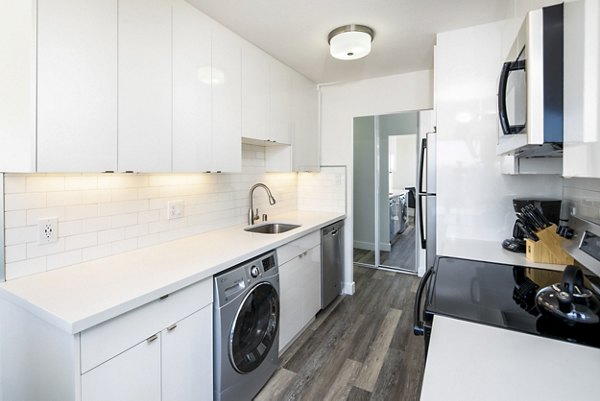 Modern kitchen featuring stainless steel appliances and granite countertops at Clay Park Tower Apartments
