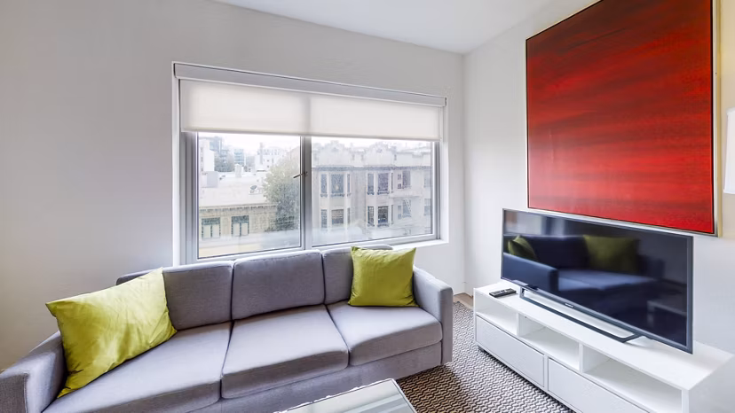 Spacious living room with modern decor and large windows at Clay Park Tower Apartments