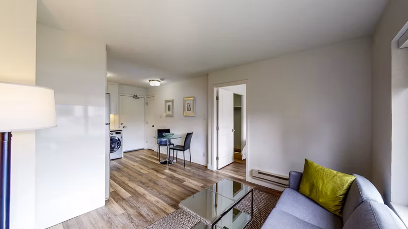 Spacious living room with elegant decor and large windows at Clay Park Tower Apartments