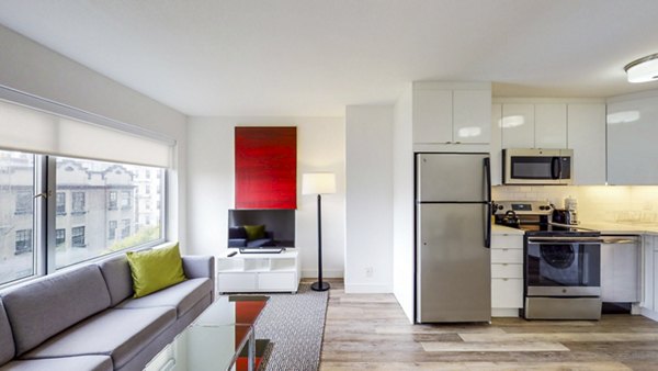 Modern living room with sleek furniture and large windows at Clay Park Tower Apartments, offering luxury living in the heart of the city