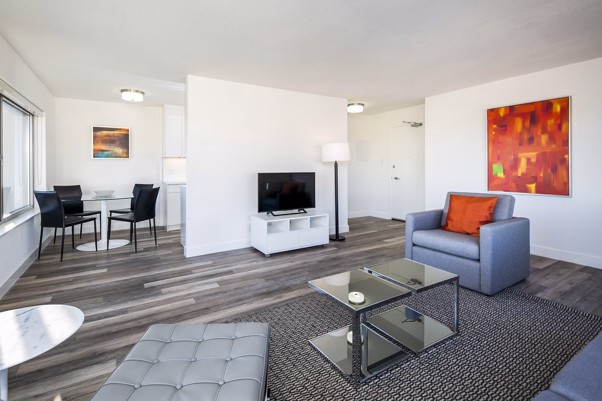 Modern living room with plush seating and large windows at Clay Park Tower Apartments