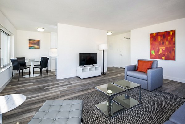 Modern living room with plush seating and large windows at Clay Park Tower Apartments