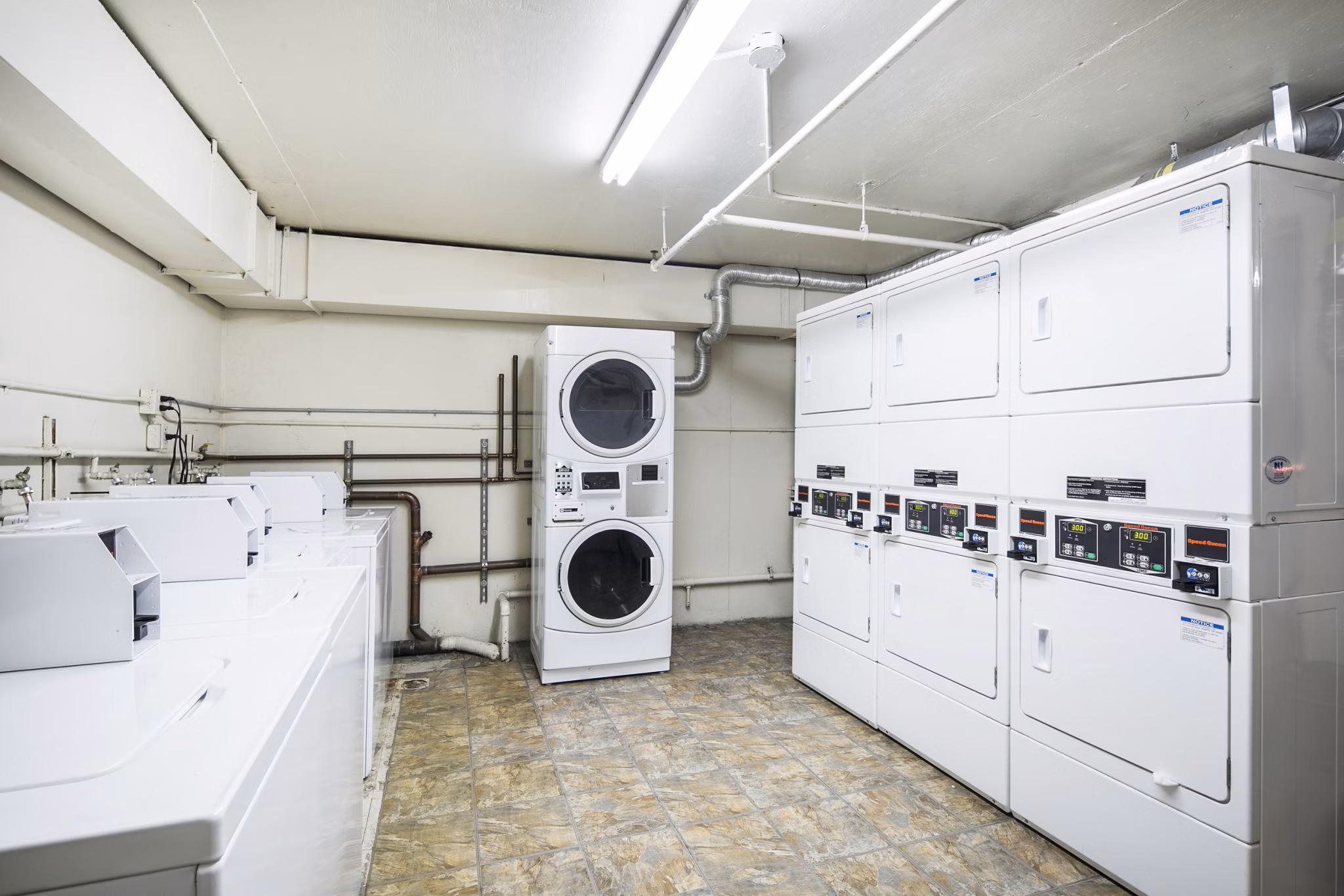 Laundry facility at Clay Park Tower: Modern laundry room equipped with washers and dryers in Greystar's luxury San Francisco apartments