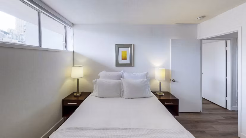 Cozy bedroom with modern furnishings at Crystal Tower Apartments, perfect for relaxation and comfort in urban living