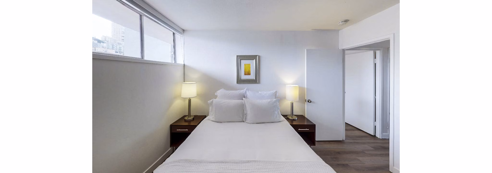 Cozy bedroom with modern furnishings at Crystal Tower Apartments, perfect for relaxation and comfort in urban living