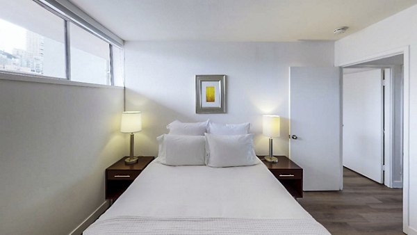 Cozy bedroom with modern furnishings at Crystal Tower Apartments, perfect for relaxation and comfort in urban living
