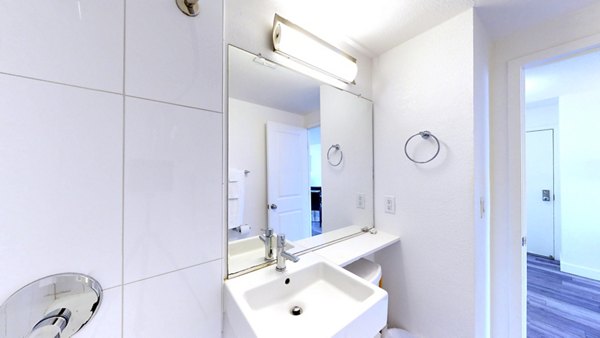 Luxurious bathroom with marble countertops and modern fixtures in Crystal Tower Apartments