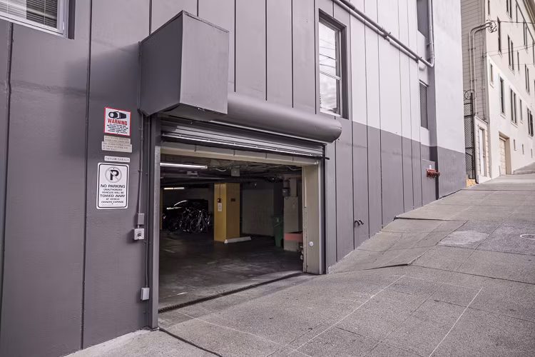 Covered parking garage at Crystal Tower Apartments providing convenient and secure vehicle storage for residents