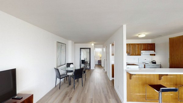Dining area with elegant lighting and modern furnishings in Crystal Tower Apartments