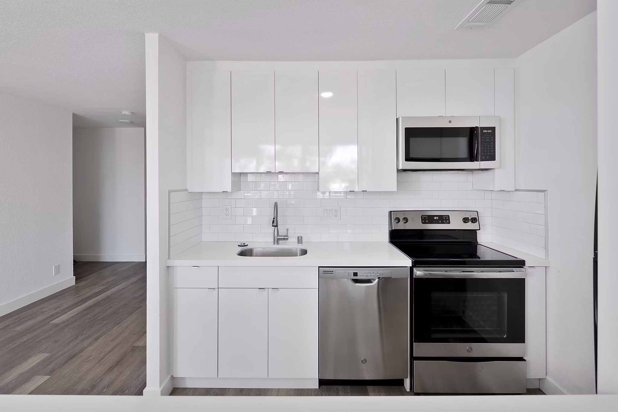 Modern kitchen featuring stainless steel appliances and granite countertops in Crystal Tower Apartments