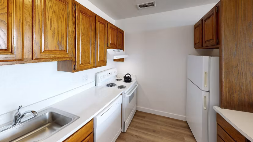 Sleek kitchen with stainless steel appliances at Crystal Tower Apartments