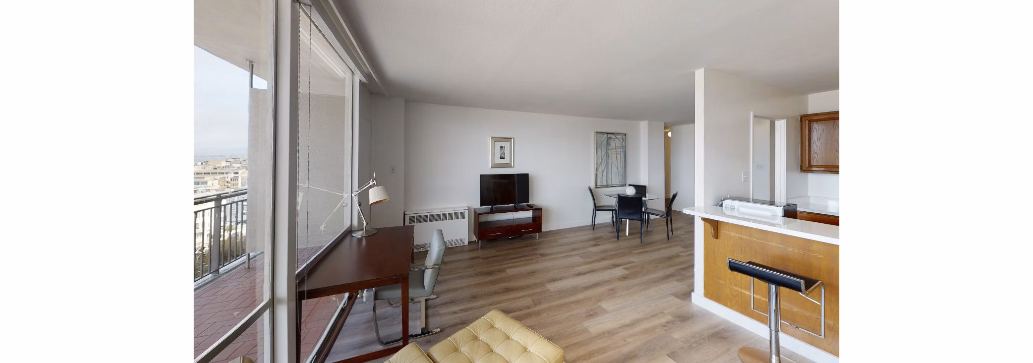 Living room with modern decor and large windows at Crystal Tower Apartments, a luxury Greystar property