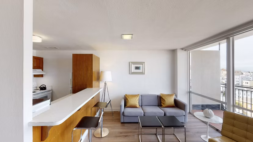 Spacious living room with modern decor and large windows at Crystal Tower Apartments