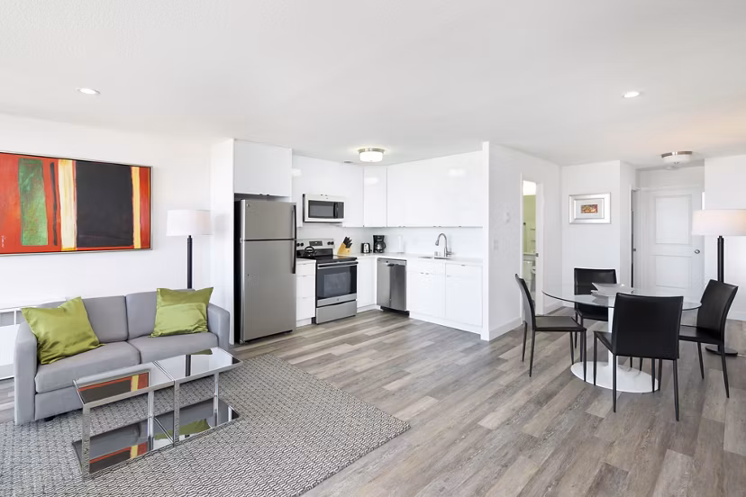 Comfortable living room with modern decor and ample natural light at Crystal Tower Apartments