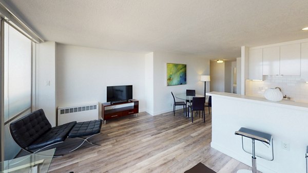 Spacious living room with contemporary furnishings at Crystal Tower Apartments