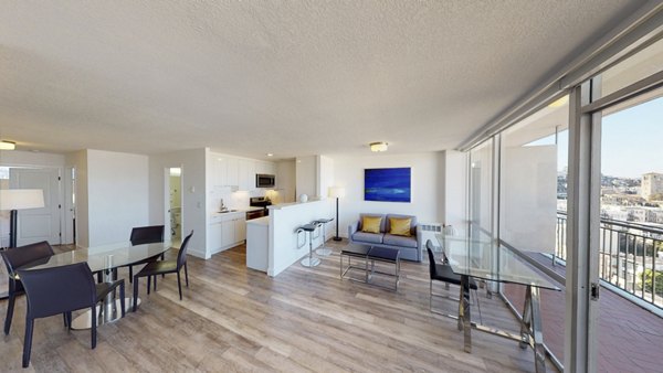 Living room featuring modern decor and large windows at Crystal Tower Apartments