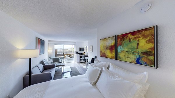 Cozy bedroom with modern decor at Marina Cove Apartments, offering luxury living with spacious layout and natural light