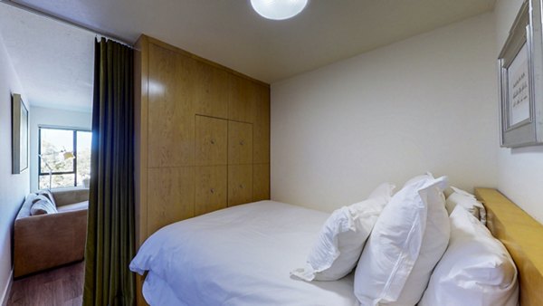 Cozy bedroom with modern furnishings at Marina Cove Apartments, offering luxury living with stylish decor and ample natural light