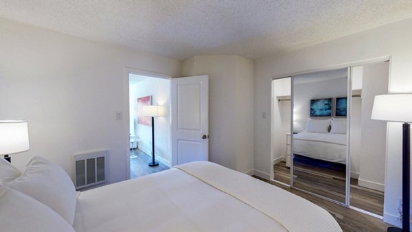 Cozy bedroom with chic bedding and modern decor in Marina Cove Apartments