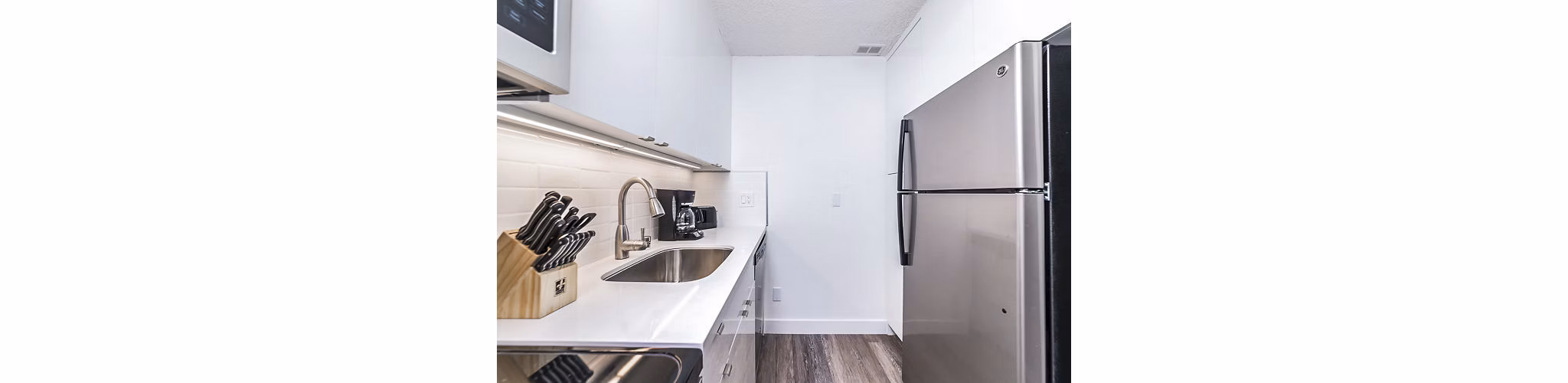 Modern kitchen with stainless steel appliances at Marina Cove Apartments, luxury living on the waterfront
