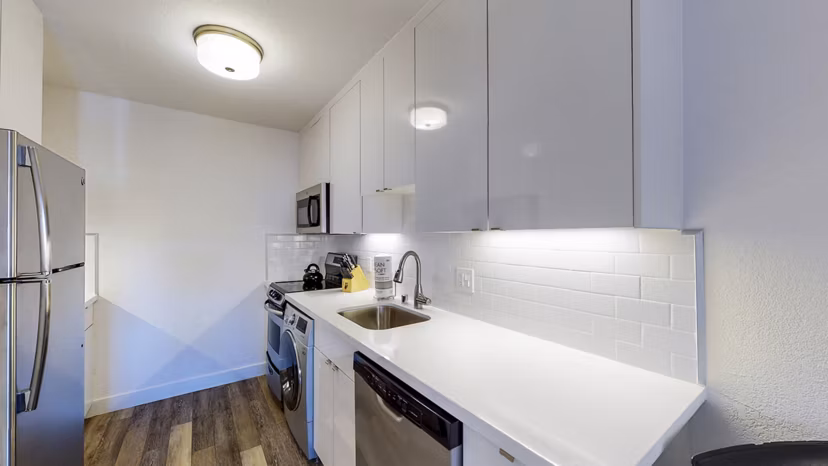 Modern kitchen with stainless steel appliances and granite countertops at Marina Cove Apartments