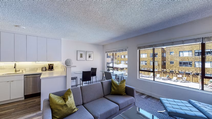 Spacious living room with modern dÃ©cor and harbor views in Marina Cove Apartments