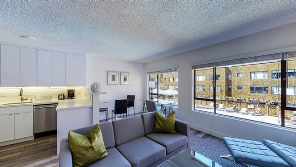 Spacious living room with modern dÃ©cor and harbor views in Marina Cove Apartments