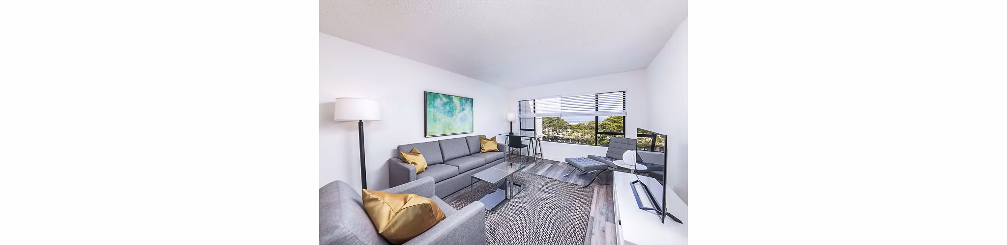 Modern living room with marina views at Marina Cove Apartments, featuring elegant furnishings and open layout