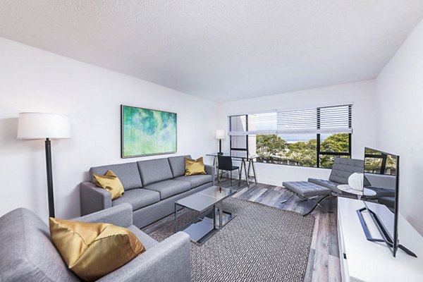 Modern living room with marina views at Marina Cove Apartments, featuring elegant furnishings and open layout