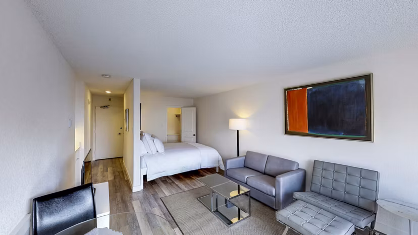 Marina Cove Apartments: Elegant living room with contemporary furnishings and large windows offering natural light