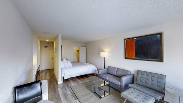 Marina Cove Apartments: Elegant living room with contemporary furnishings and large windows offering natural light