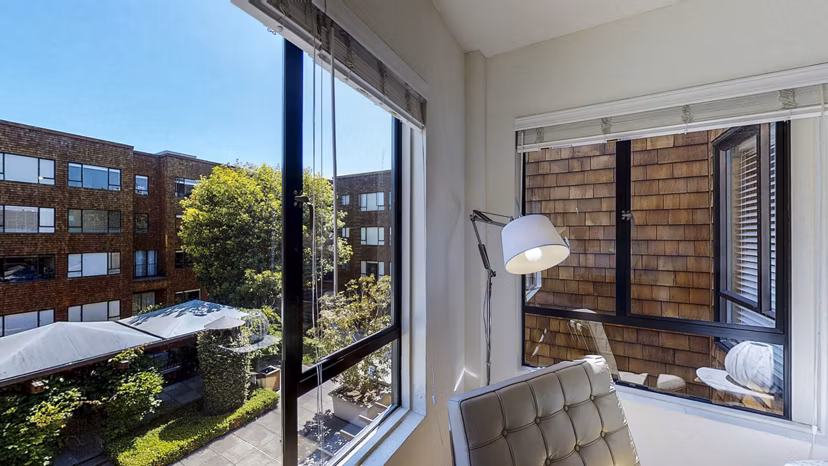 Spacious living room with elegant decor and large windows at Marina Cove Apartments