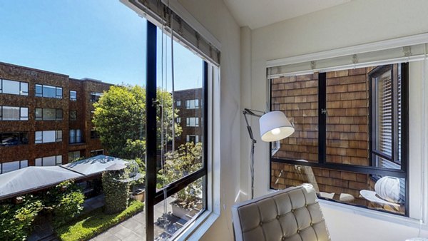 Spacious living room with elegant decor and large windows at Marina Cove Apartments