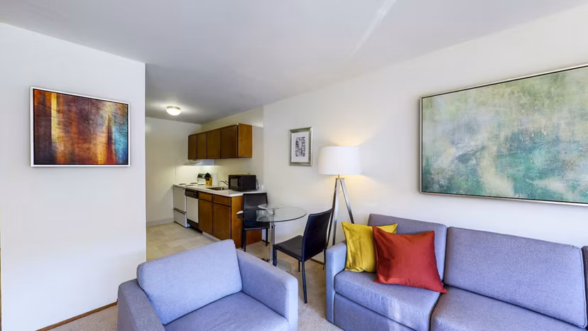 Bright living room with modern decor and large windows at Marina Cove Apartments