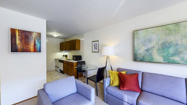 Bright living room with modern decor and large windows at Marina Cove Apartments