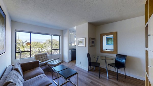 Modern living room with large windows at Marina Cove Apartments