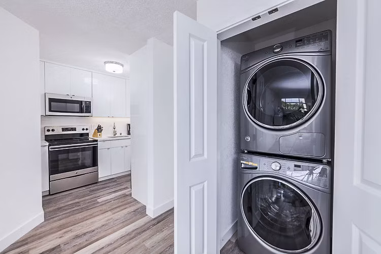 Laundry room with modern appliances at Marina Cove Apartments offering convenient and efficient washing facilities