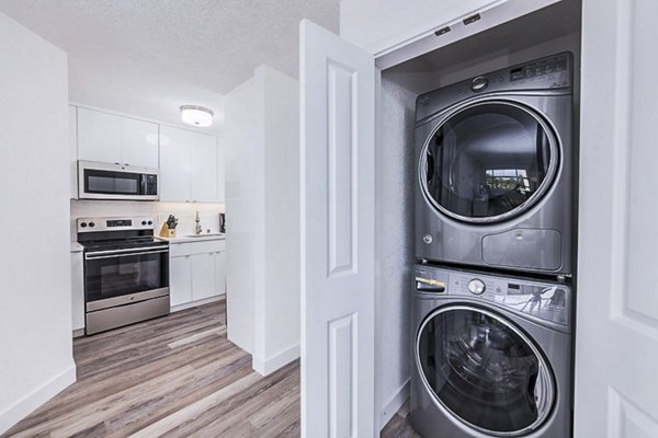 Laundry room with modern appliances at Marina Cove Apartments offering convenient and efficient washing facilities