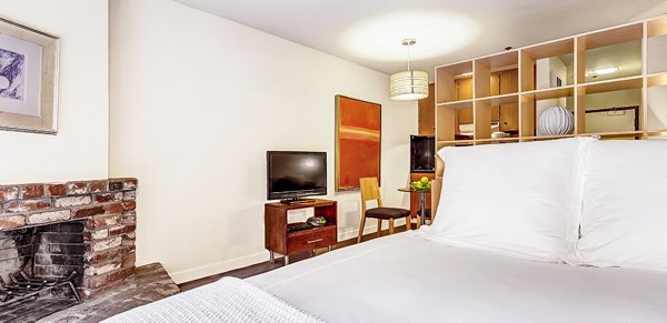Cozy bedroom with modern decor and ample natural light at Telegraph Hill Apartments luxury residences
