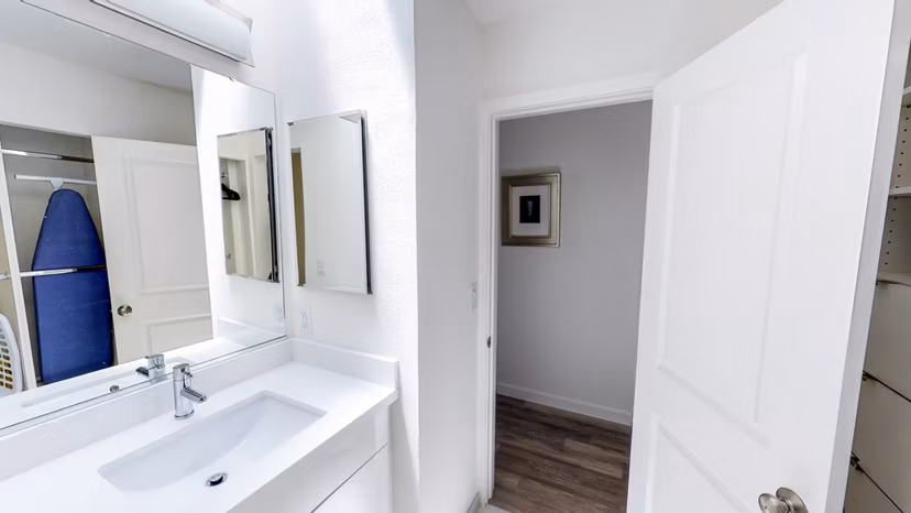Elegant bathroom with marble countertops and glass shower in Telegraph Hill luxury apartments