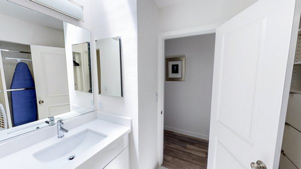 Elegant bathroom with marble countertops and glass shower in Telegraph Hill luxury apartments
