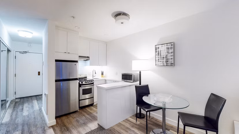 Dining room with elegant lighting and modern furnishings at Telegraph Hill Apartments