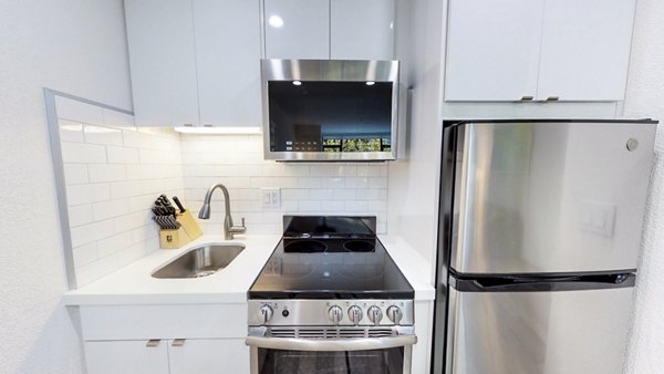 Stylish kitchen featuring modern appliances and granite countertops at Telegraph Hill Apartments in San Francisco