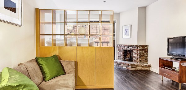 Modern living room with plush seating and large windows at Telegraph Hill Apartments